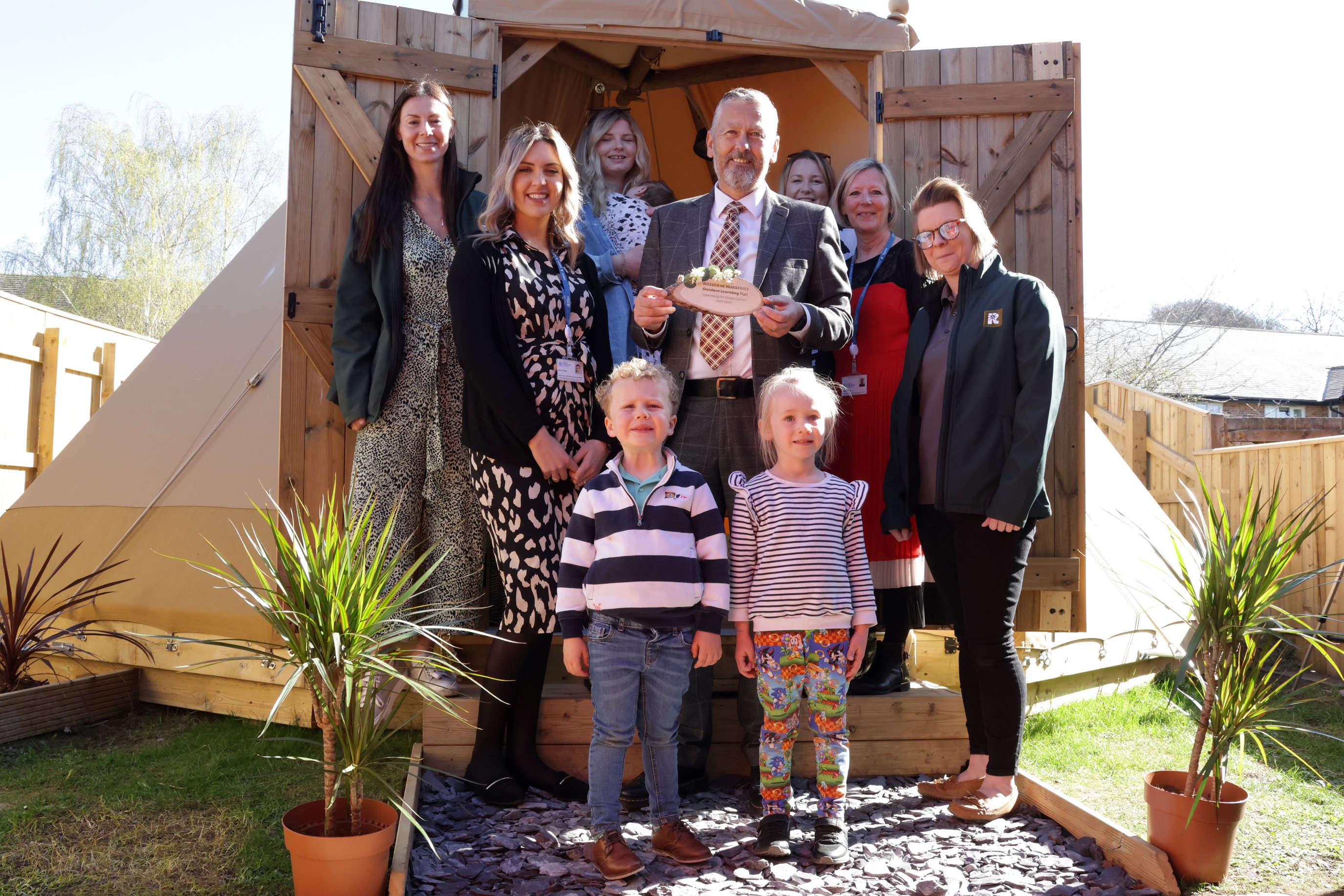 A group of people outside a tipi