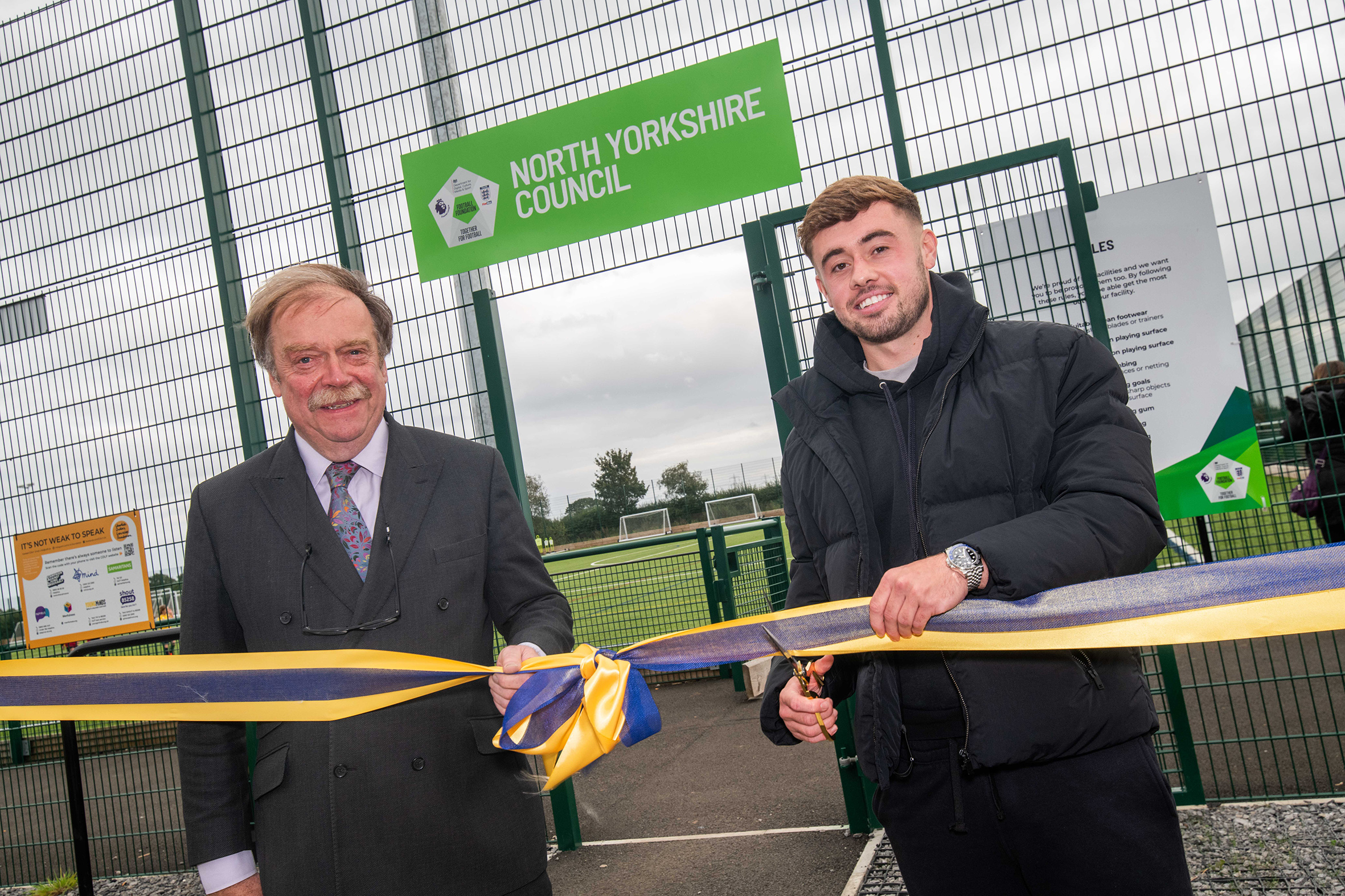 Cllr Simon Myers and professional footballer Alfie McCalmont cut the ribbon to officially open the new 3G pitch and pavilion in Sowerby.