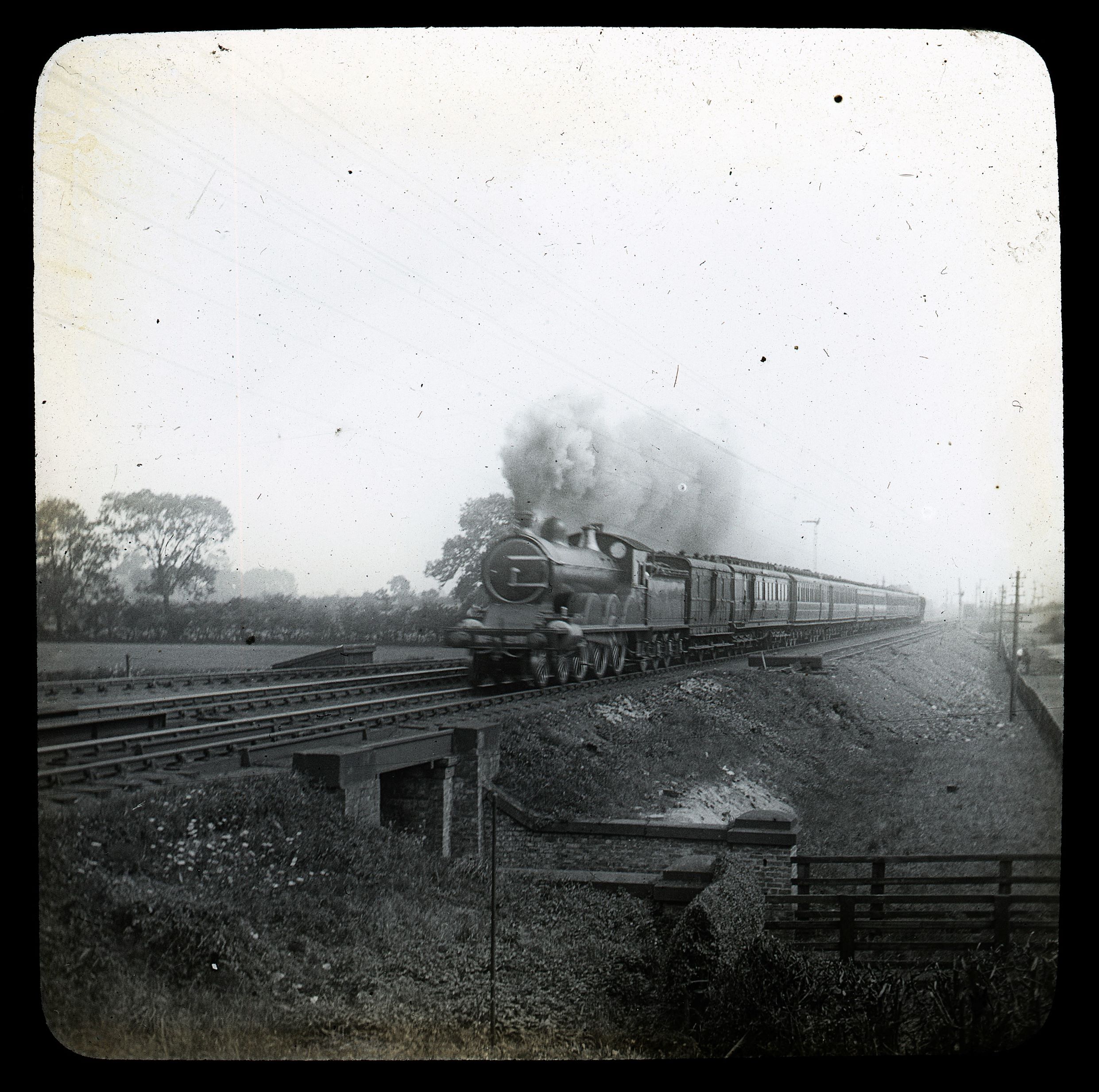 A stream train thunders along. From the Scruton Lantern Slides collection.