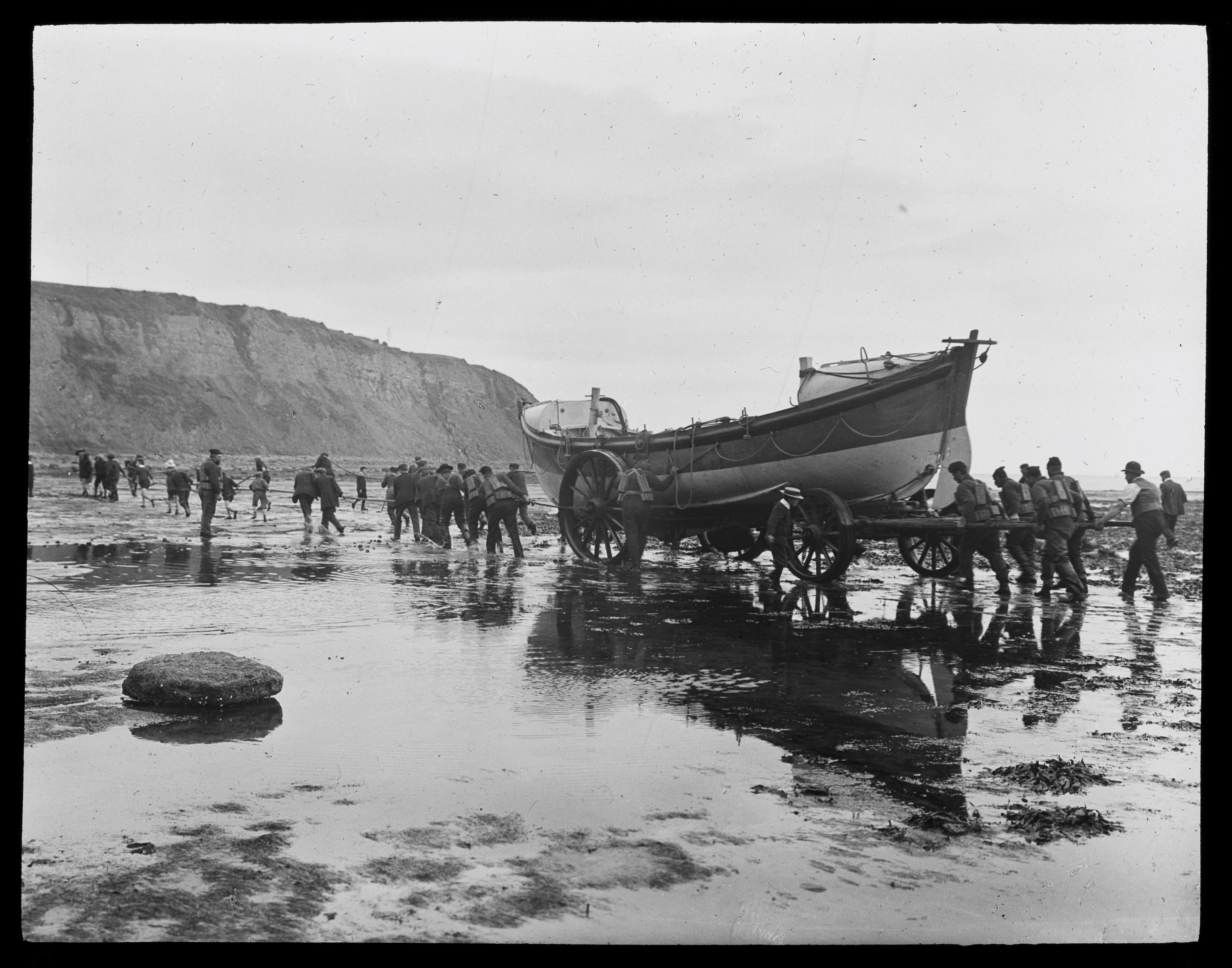 Lifeboatmen launching at Robin Hood’s Bay (no date), by Graystone bird, in the Tour of Yorkshire collection.