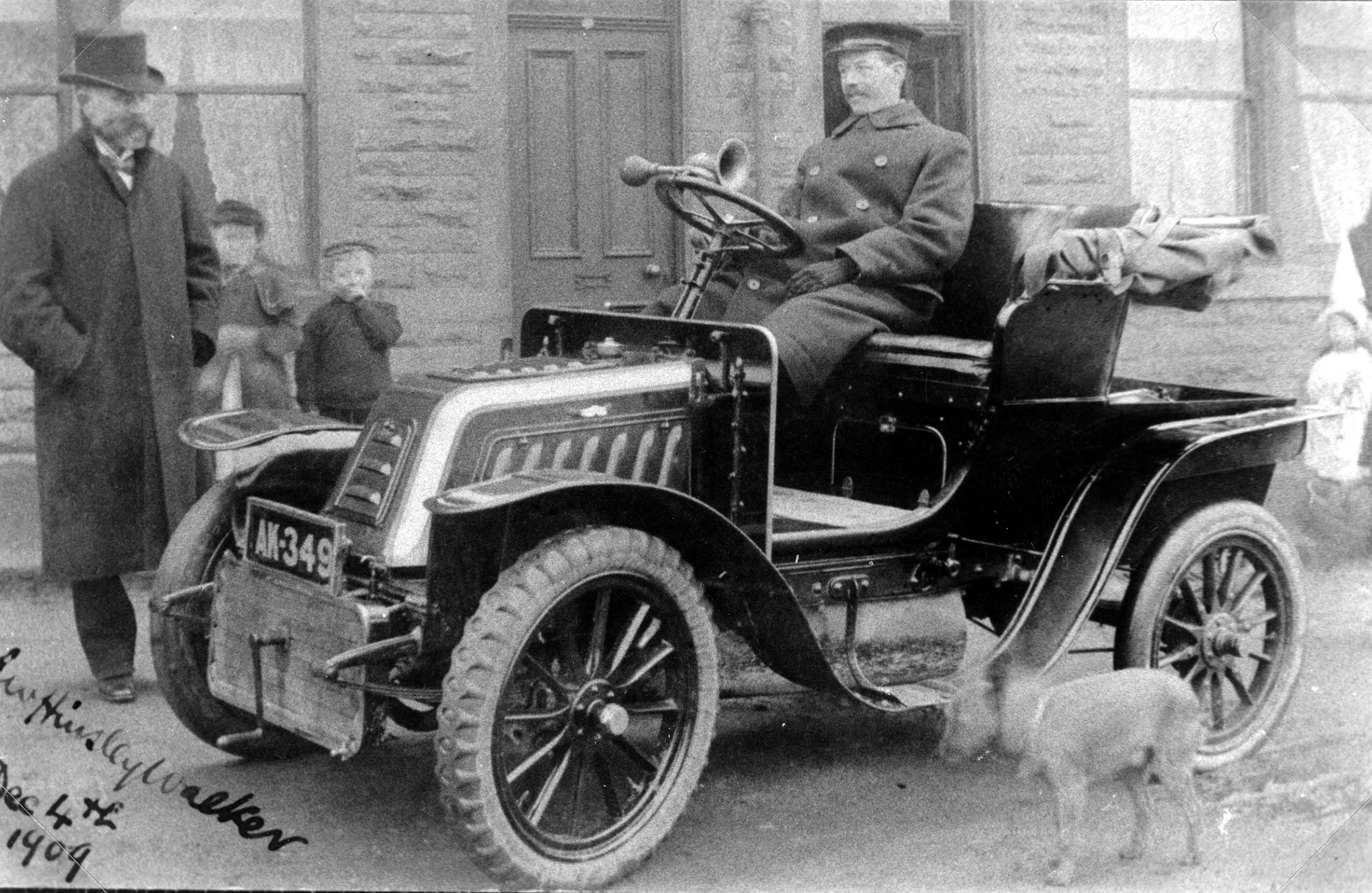Dr Hinsley Walker standing beside his chauffeur driven car in Harrogate, in December 1909. From the Bertram Unné photographic collection.