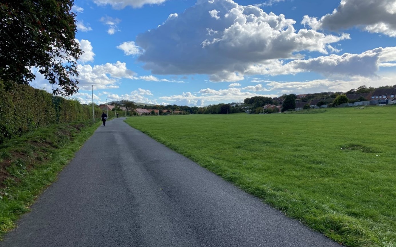 A vast open space of underutilised mown grass