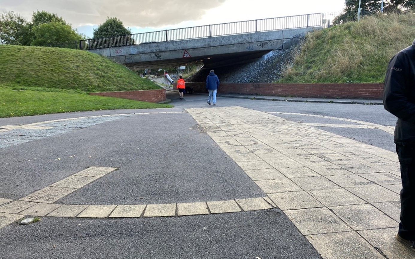 The existing paving design and grassed embankments at Woodland Ravine