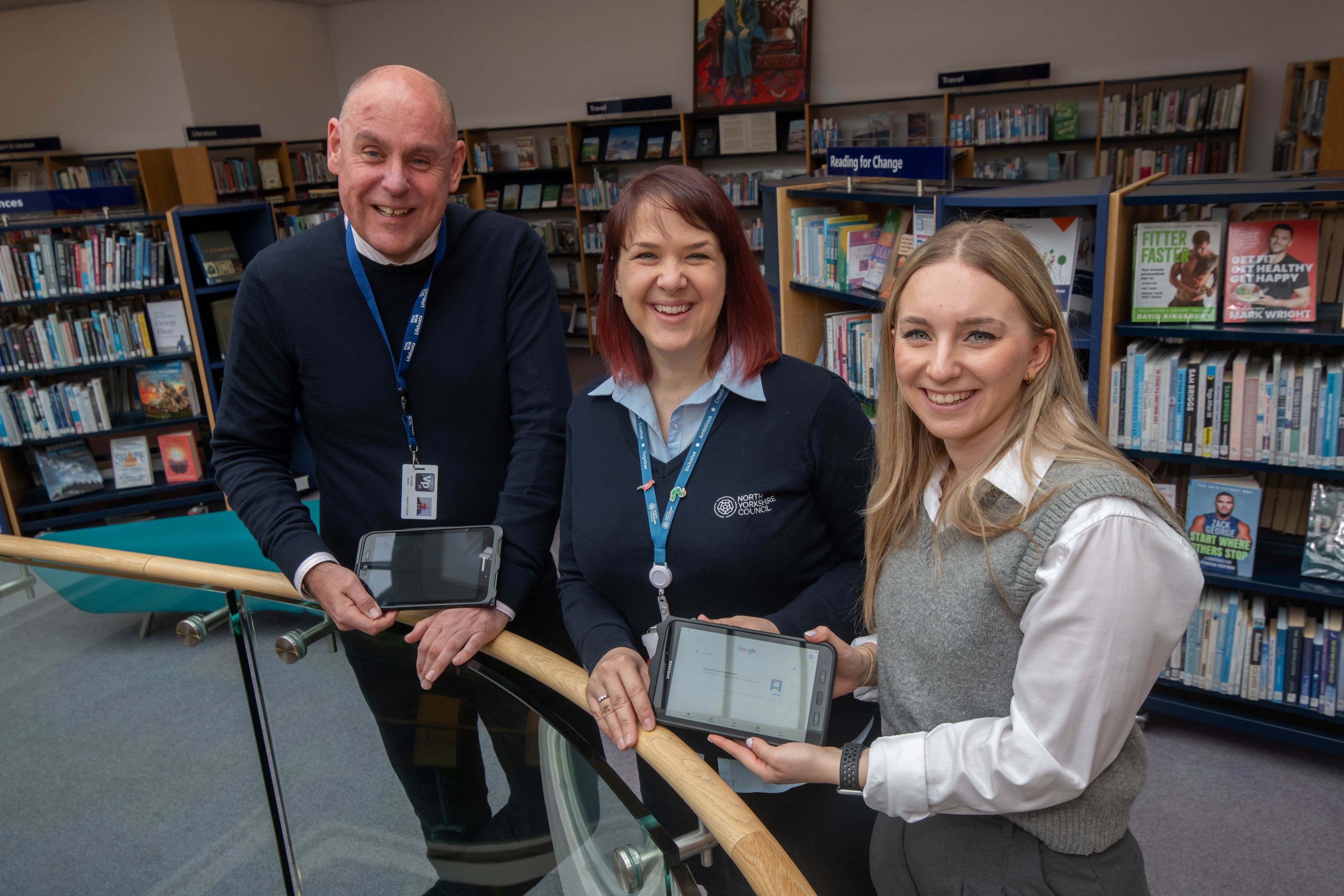 Three people in Harrogate library with devices