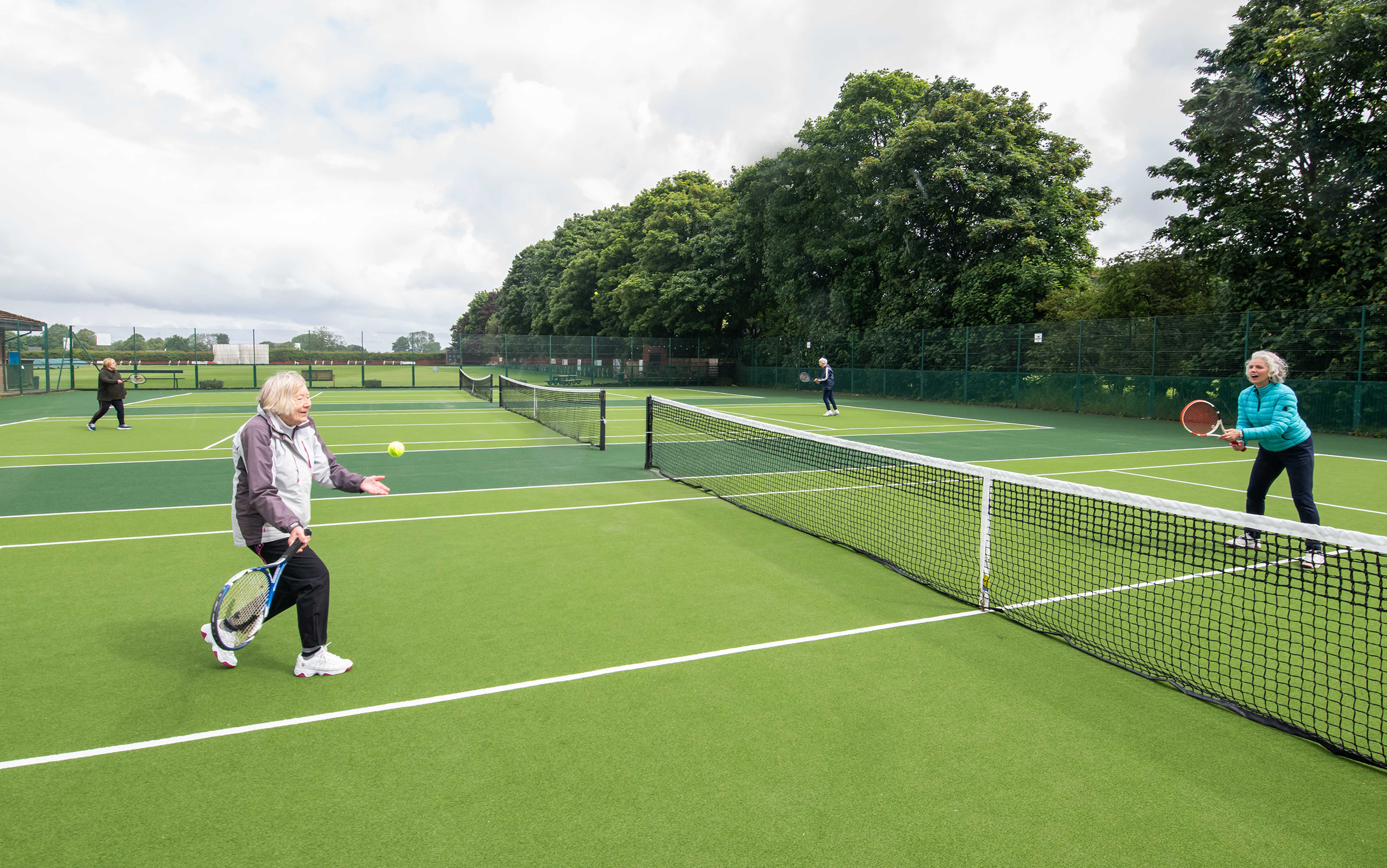 Members of a Rusty Racquets session play a game of tennis on the newly resurfaced courts in Stokesley