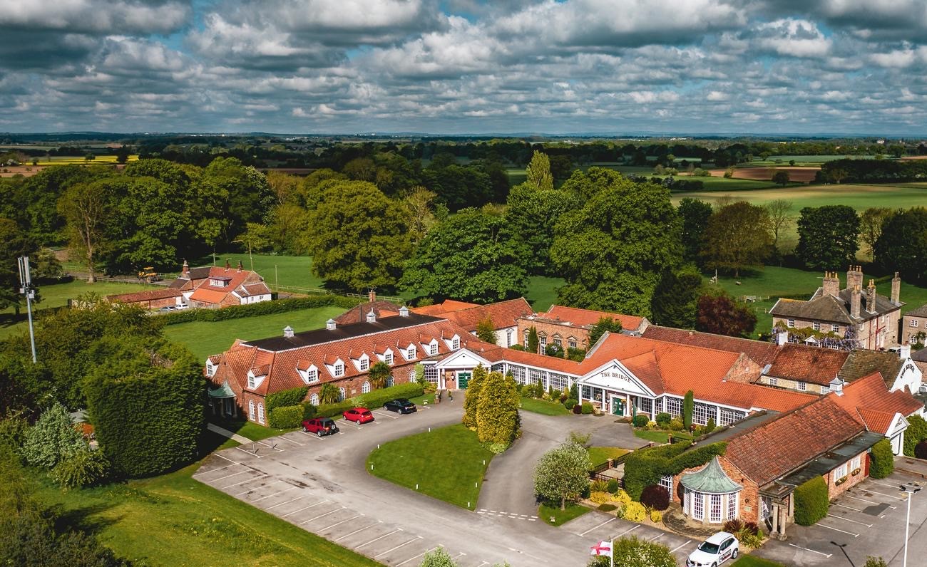 A aerial drone photo of the Bridge Inn, a country house.