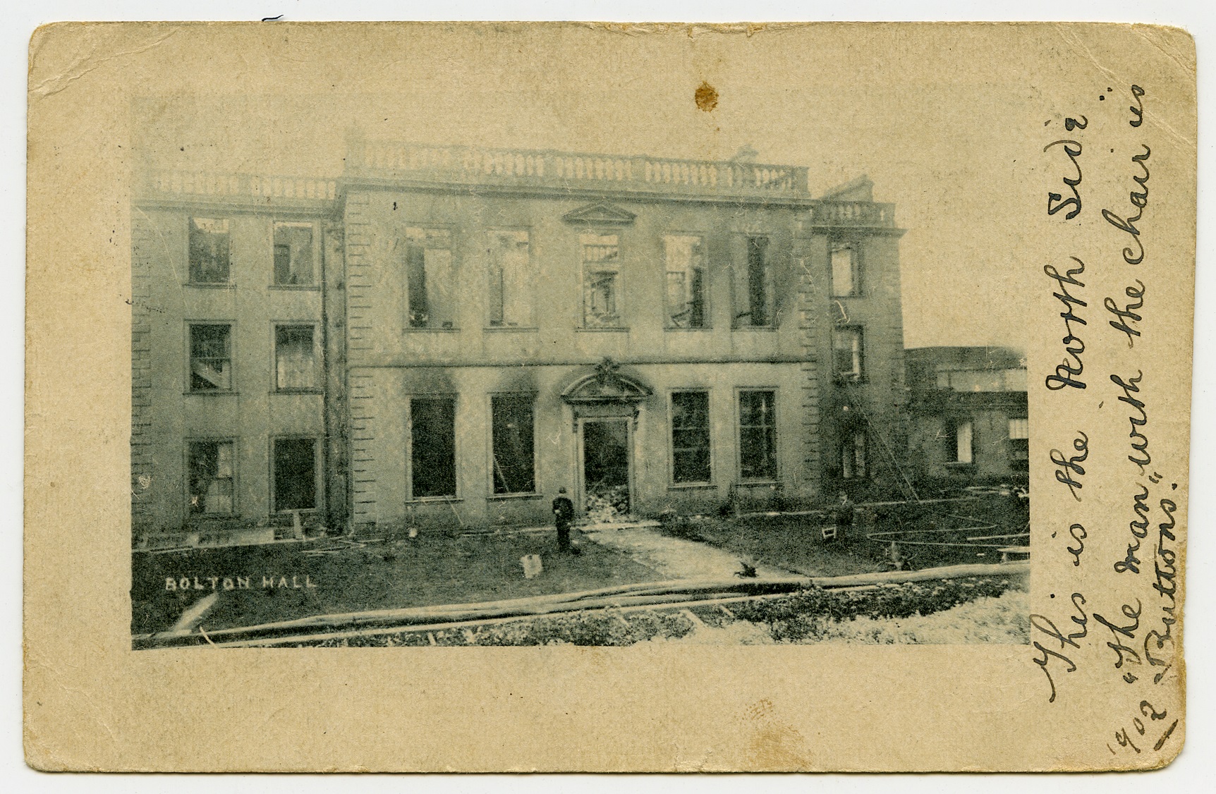 ‘Buttons’ and a policeman at Bolton Hall, following the fire in 1902.