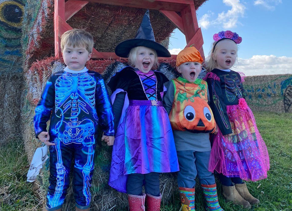 Four children in Halloween costumes 