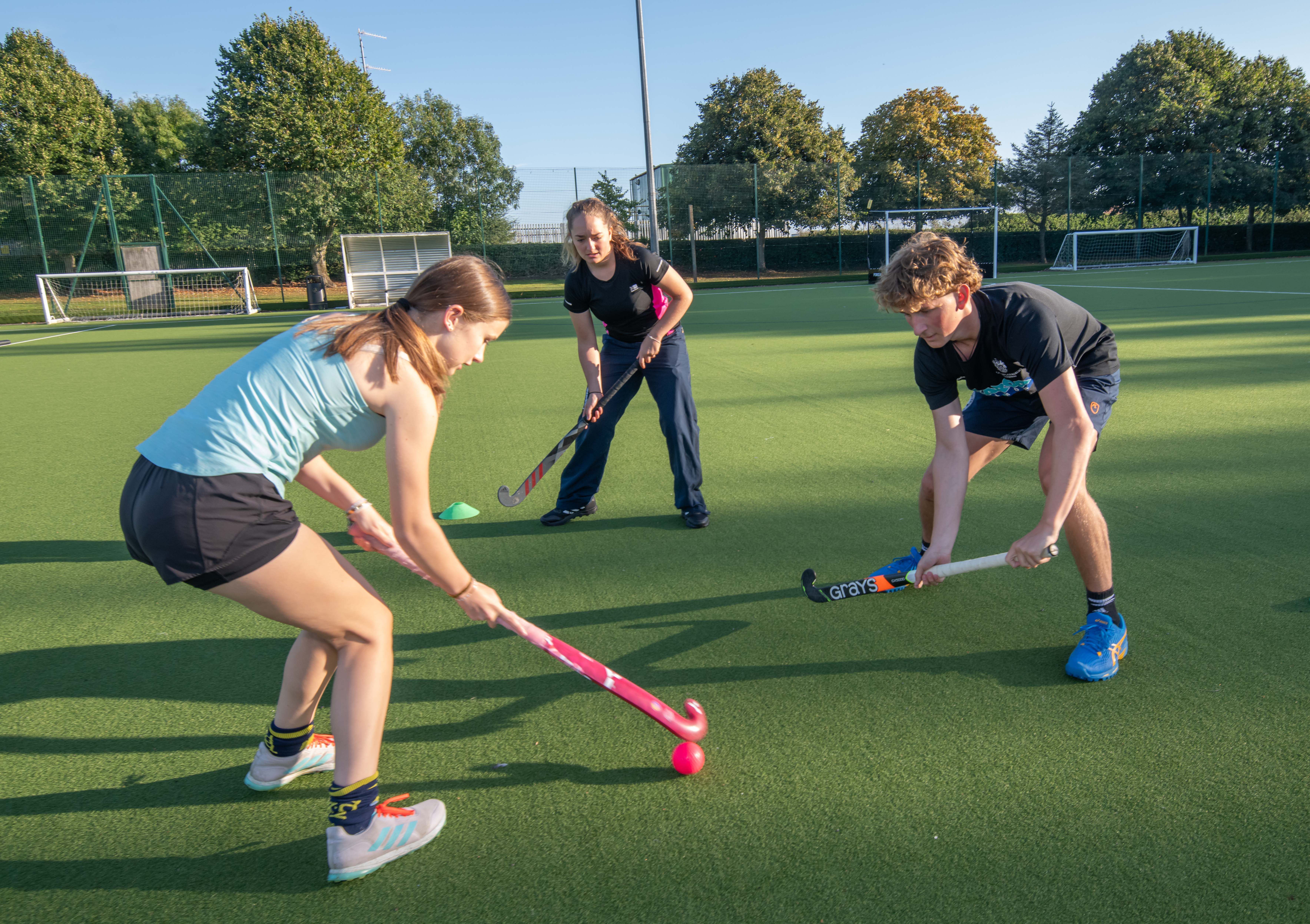 A group of teens playing hockey