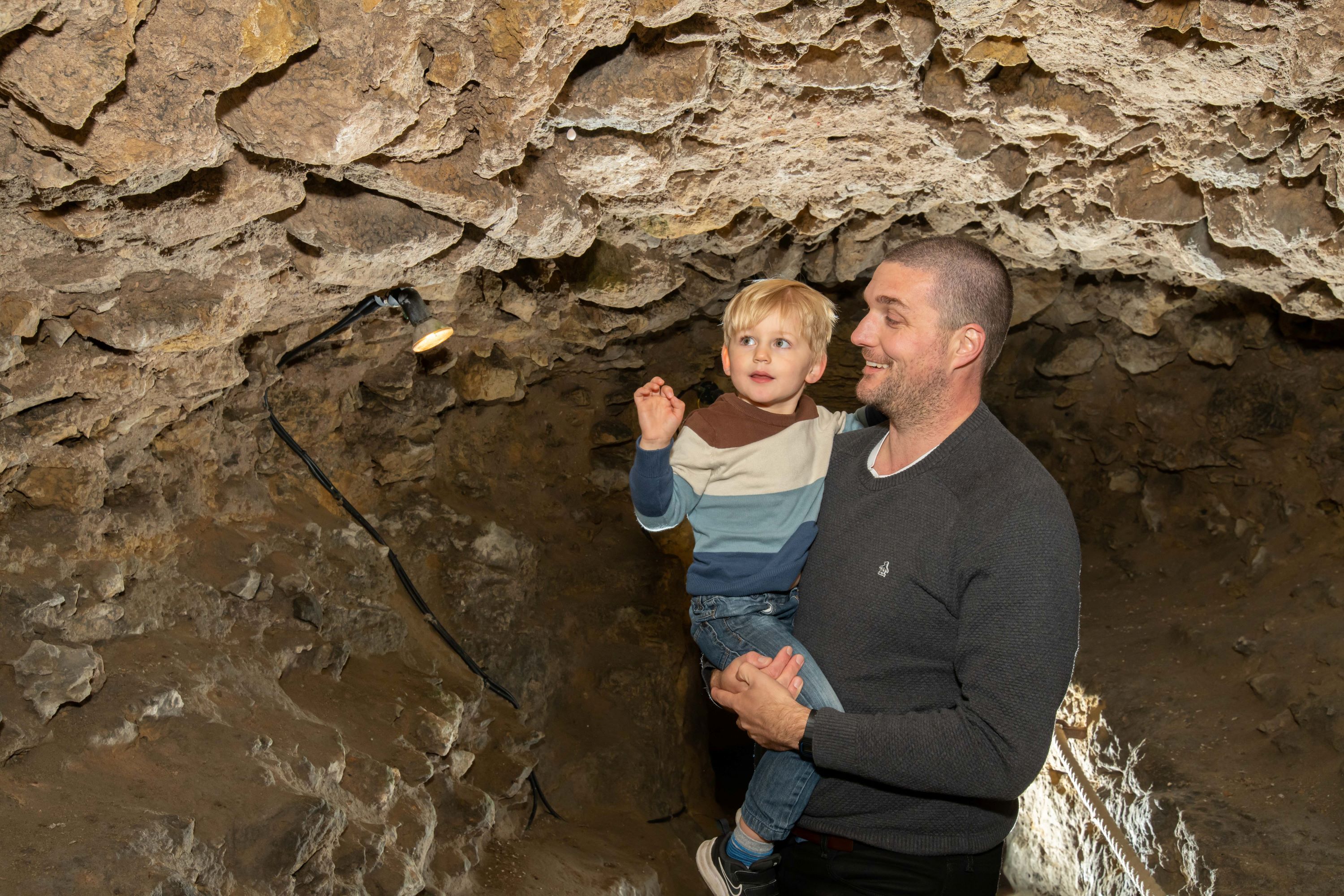 Visitors to Knaresborough Castle explore the underground tunnels.