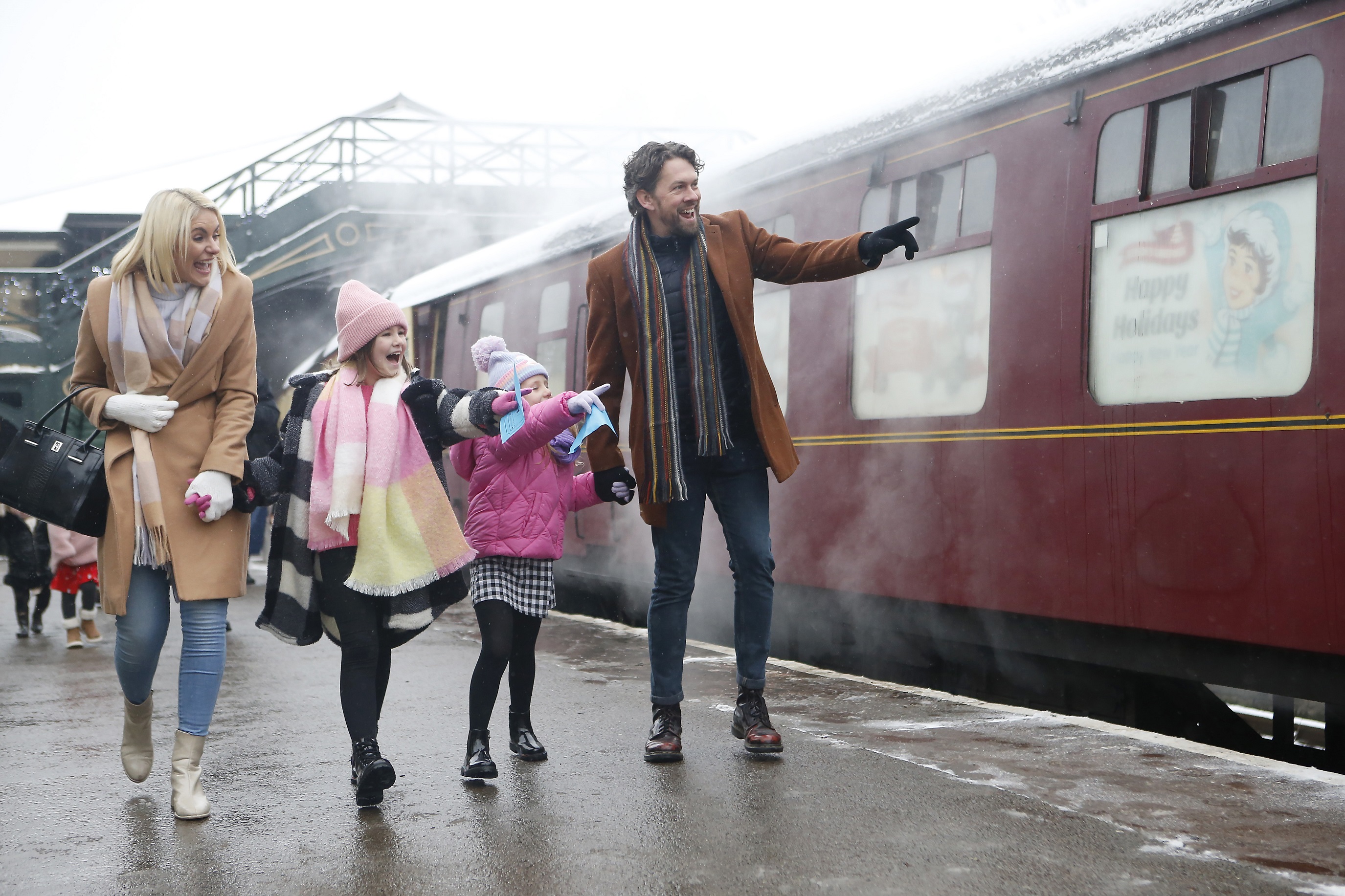 Family walking alongside the Santa Special train.