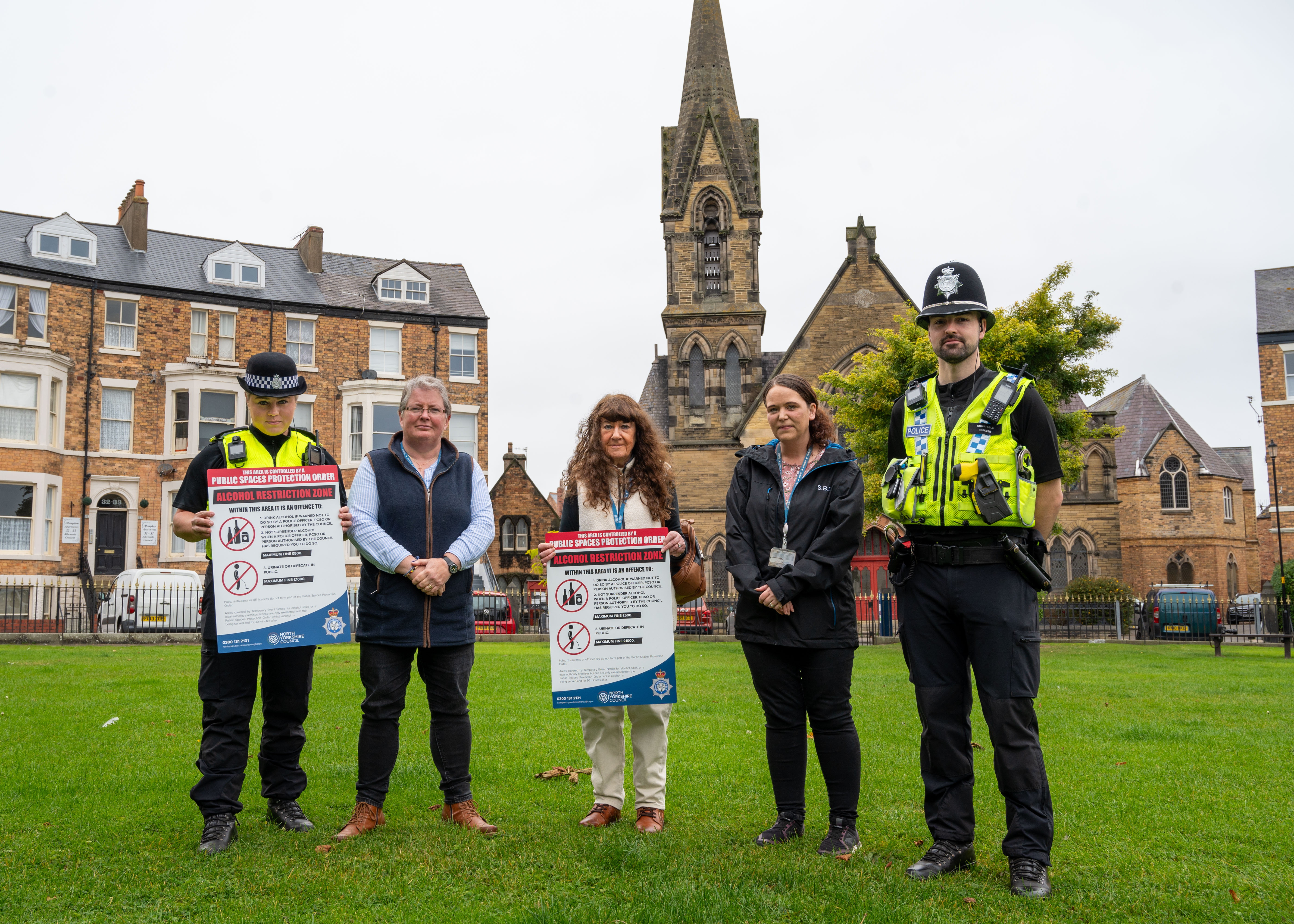 Five people with signs in Scarborough