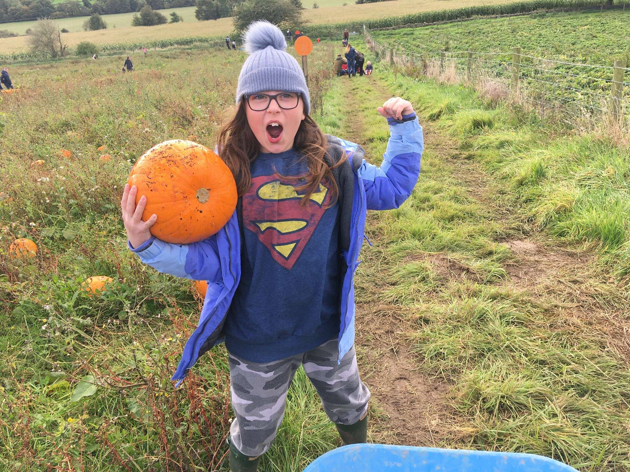 A young girl holding a pumpkin