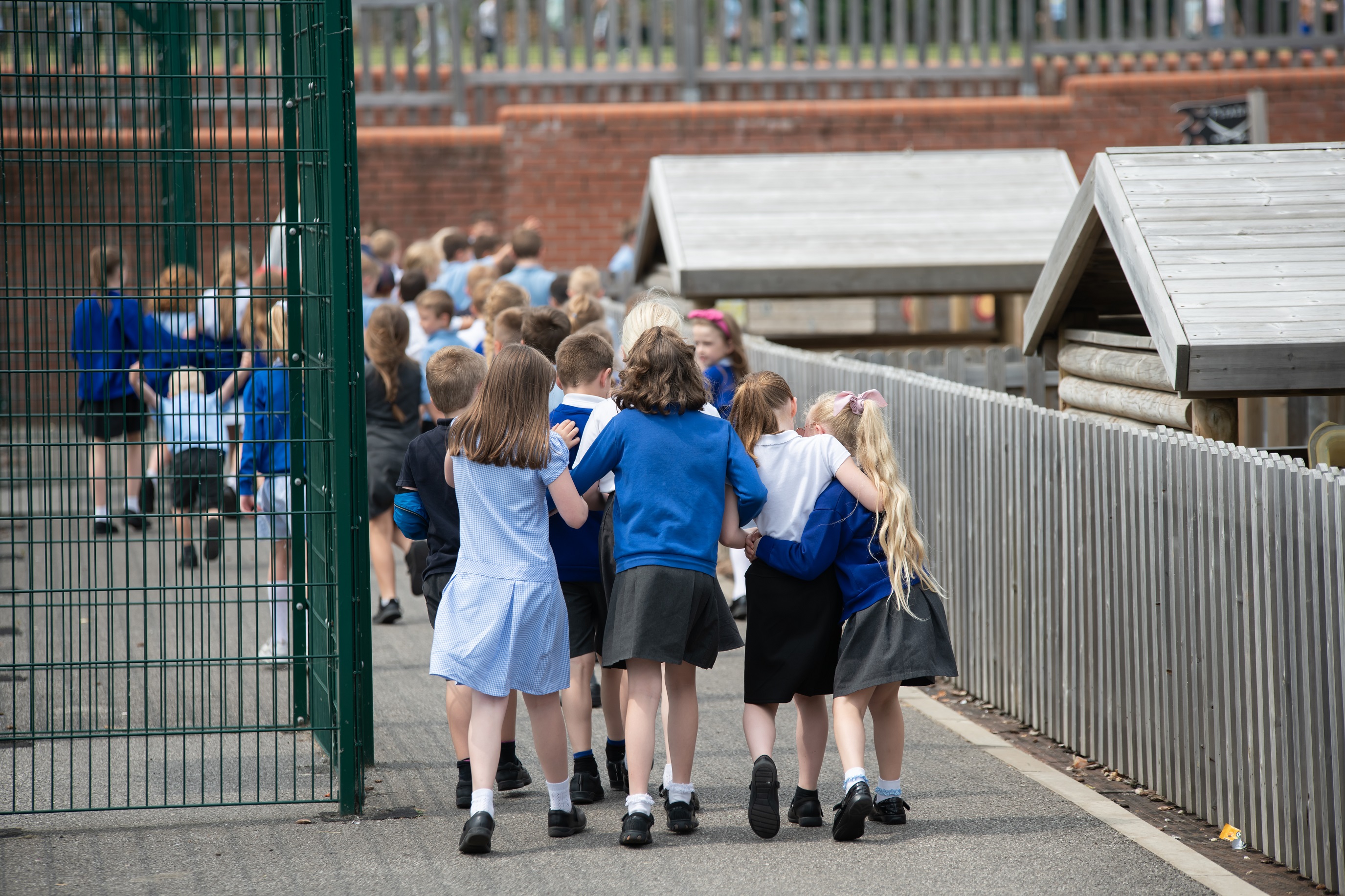 Primary school children walking into school