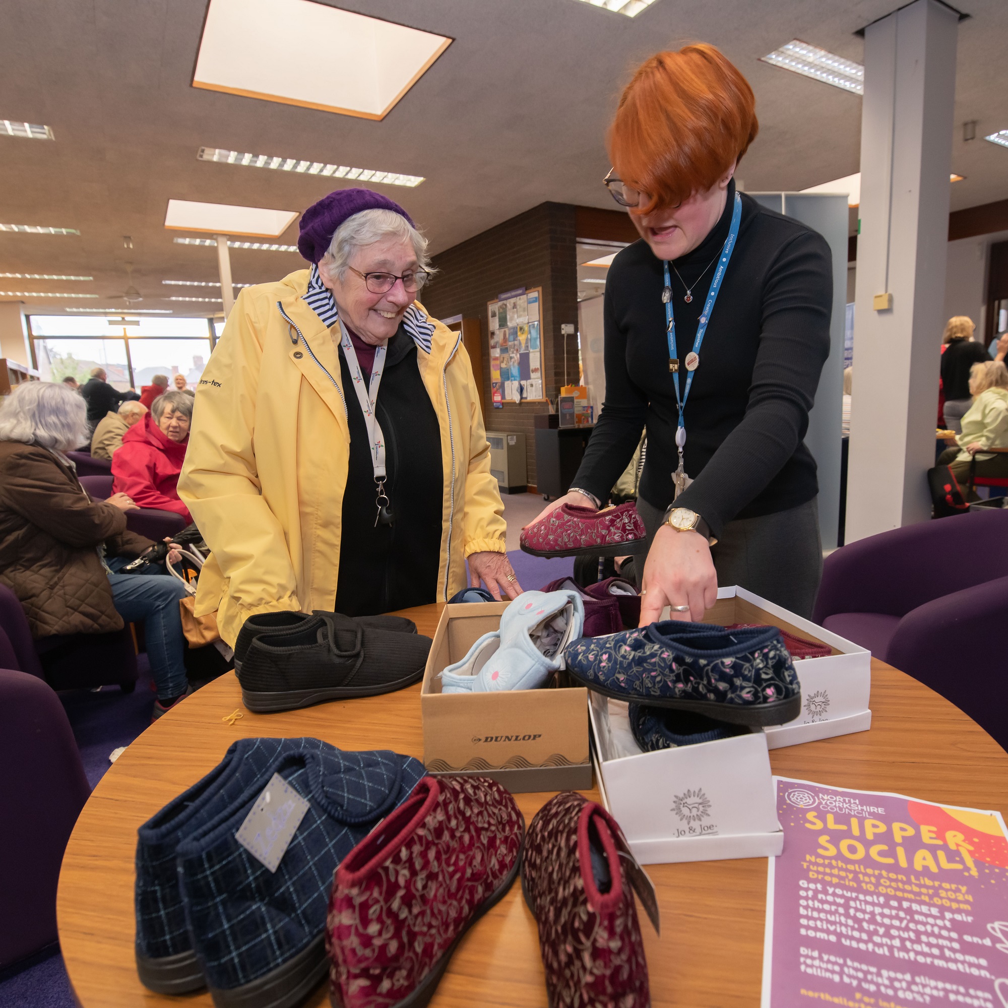 Dorothy and Philippa looking at slippers in a library