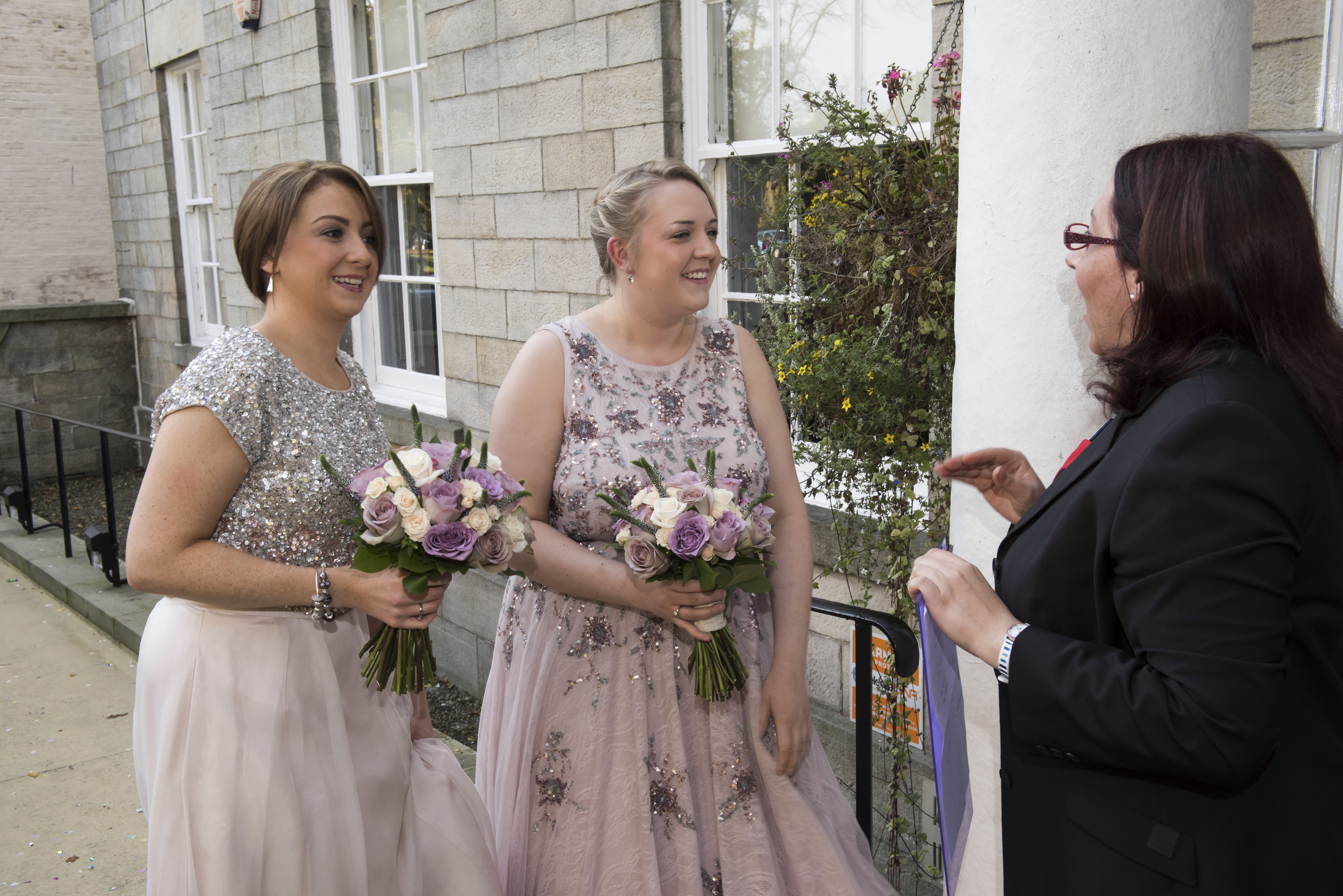 Two brides speaking to the registrar