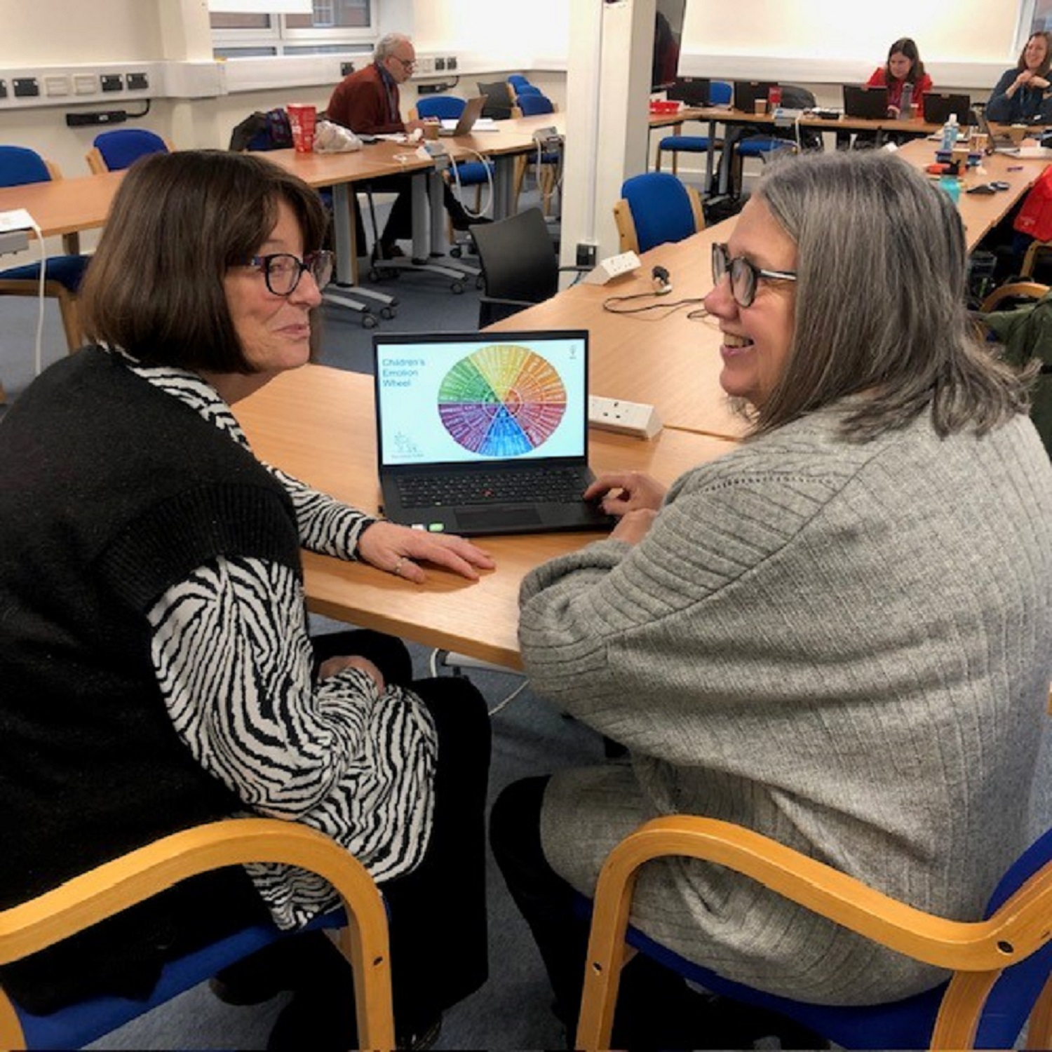 Two ladies looking at the family toolkit