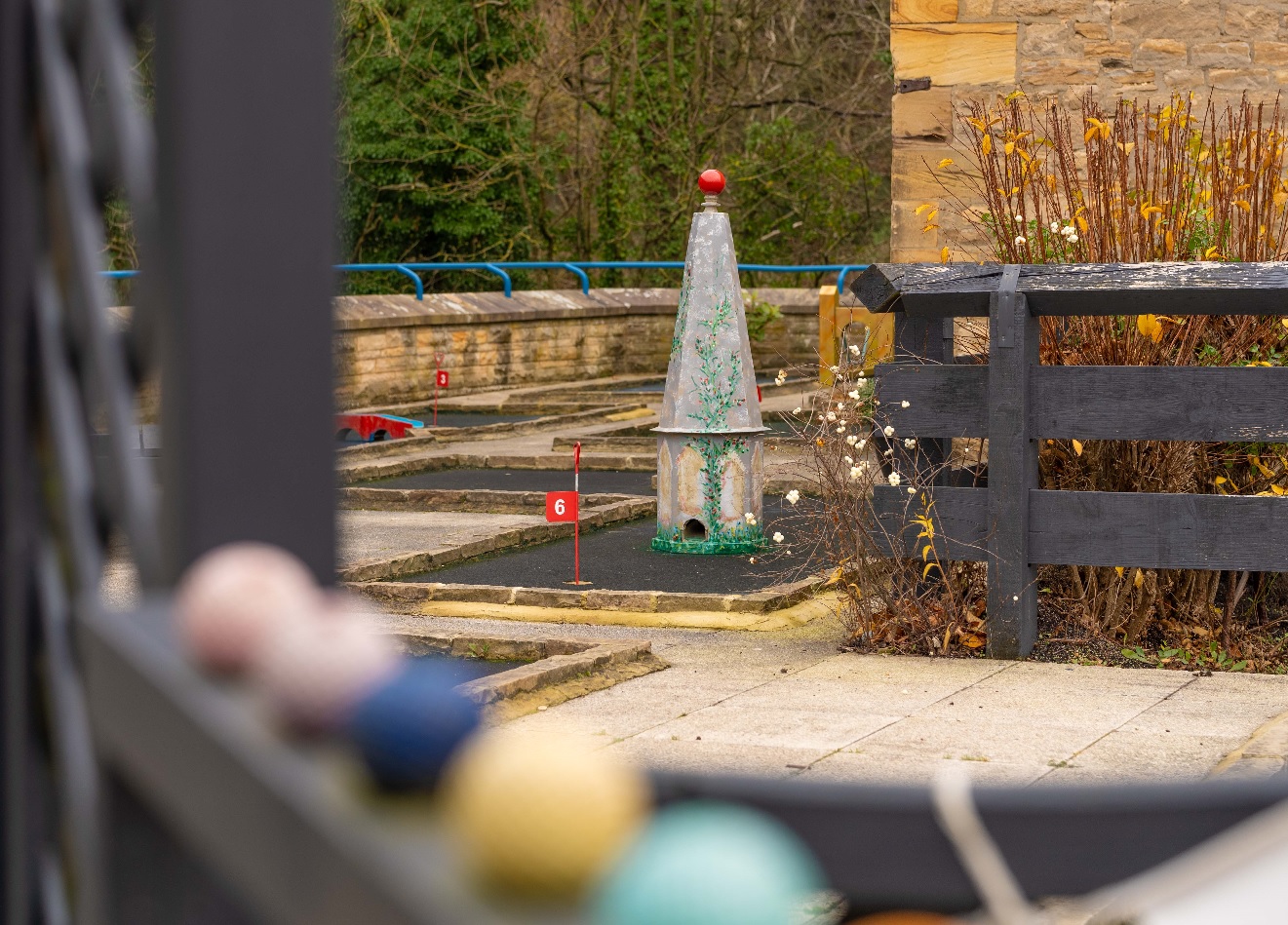 One of the holes on Richmond Leisure and Wellbeing Hub mini golf course with some golf balls in the foreground.