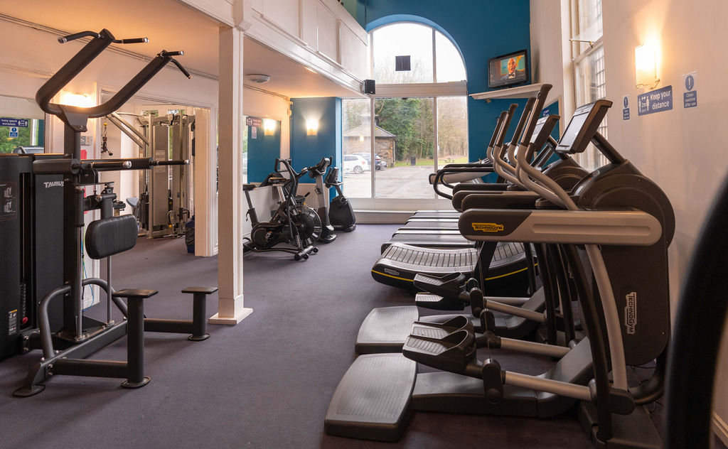 The gym at Richmond Leisure and Wellbeing Hub including weight machines and treadmills.