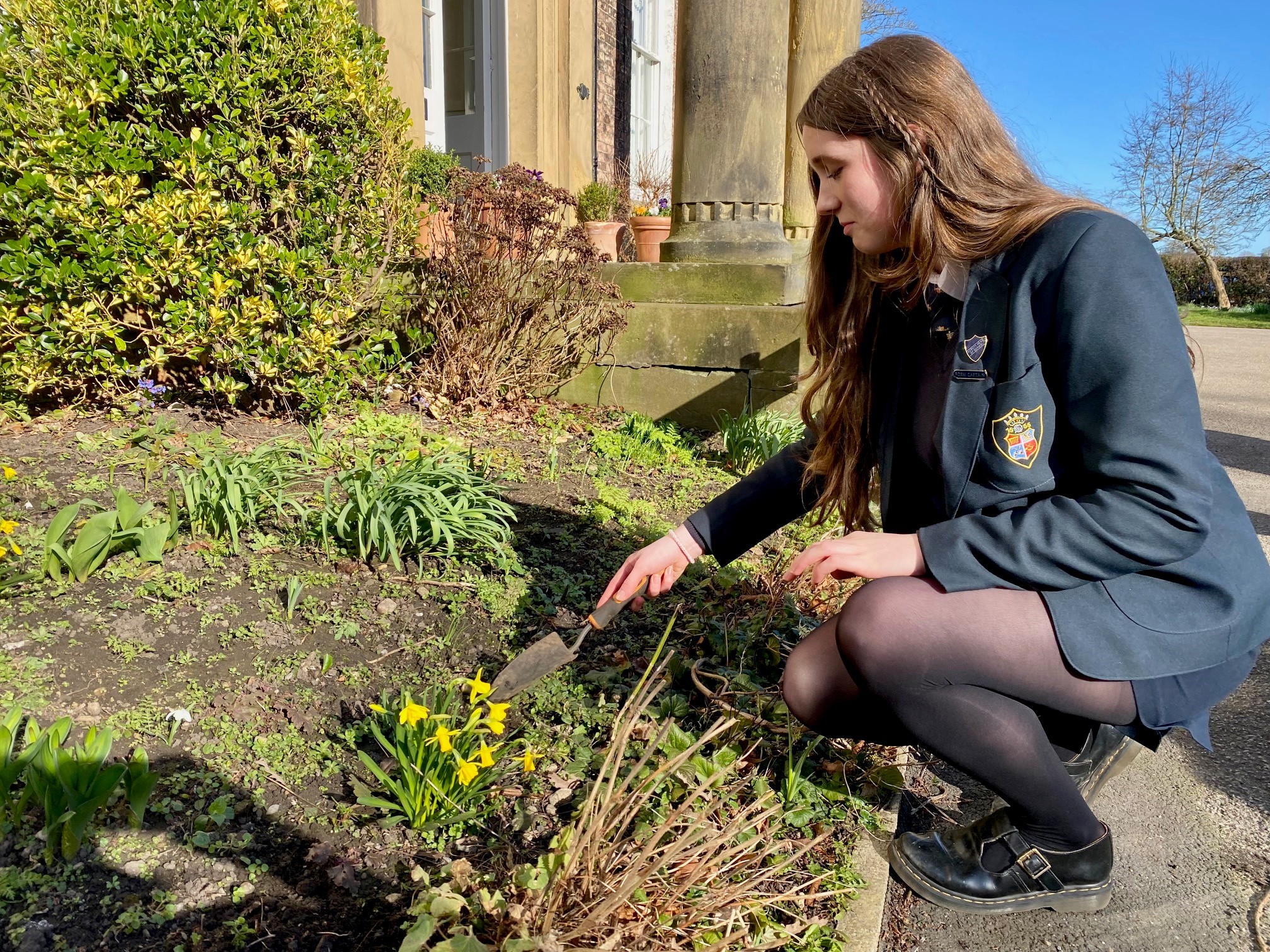 A girl gardening at Ripon Grammar school