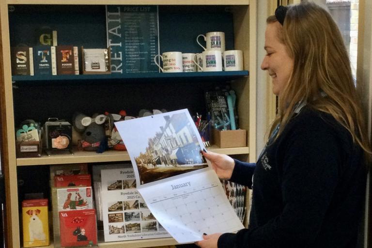 Beccy Roberts, library supervisor, looking at a calendar