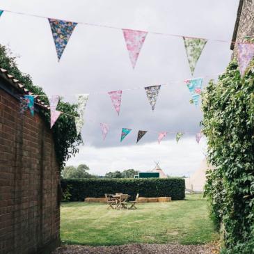 Bunting set up on an open space at the wedding venue. 