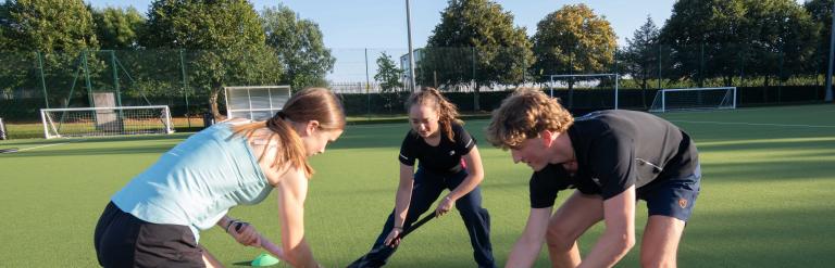 A group of teens playing hockey