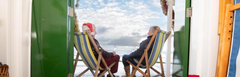 People outside beach huts