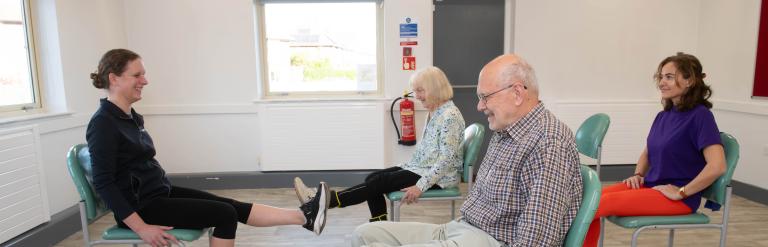 People doing seated exercises 